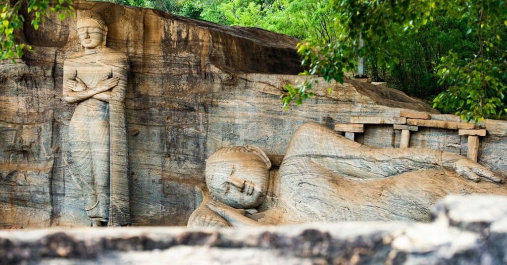 Rock carvings of standing and reclining Buddhas at the ancient Polonnaruwa site in Sri Lanka.