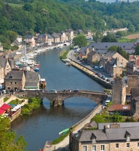 Brittany Stunning coastal view of Brittany, France, featuring rugged cliffs, charming lighthouses, and picturesque villages along the coastline, with the sparkling blue waters of the Atlantic Ocean in the background.